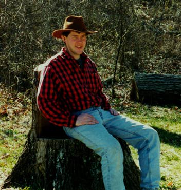 Dave sitting on a chair made from an old tree stump