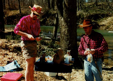 Dave and Tom standing by a camping table at lunch