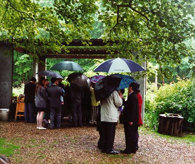 People milling about under umbrellas